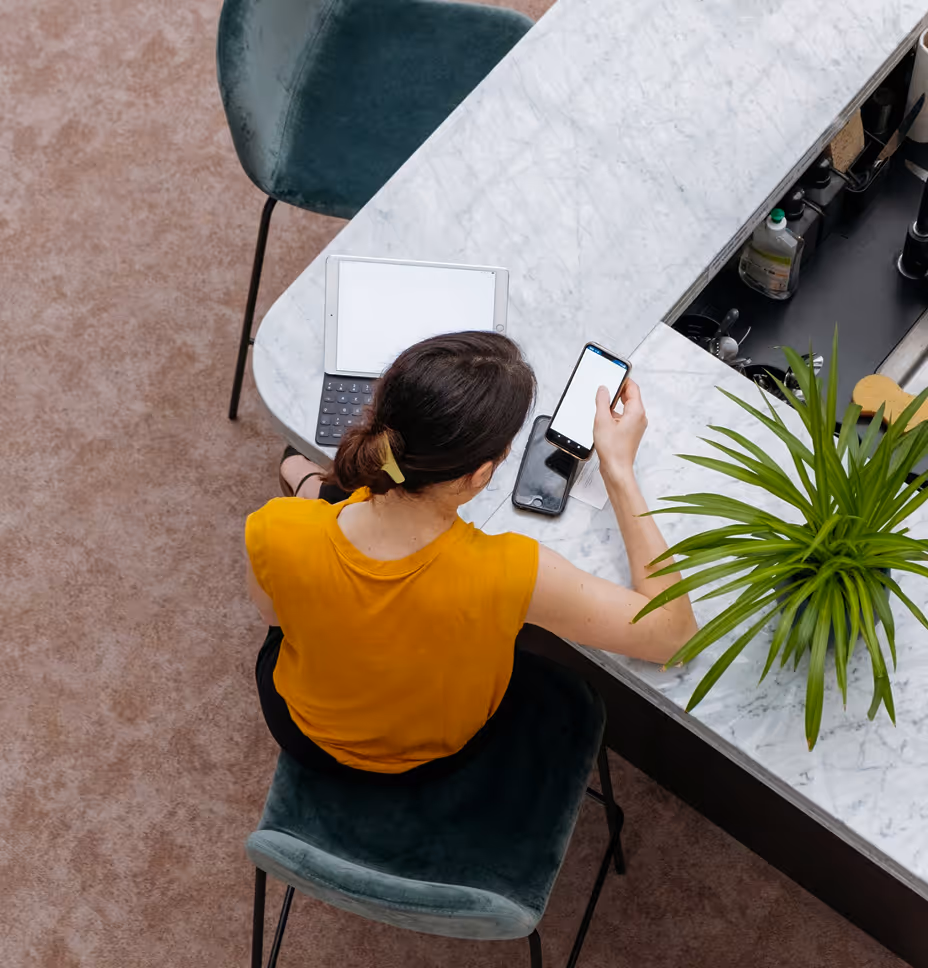 Person working at a table with devices